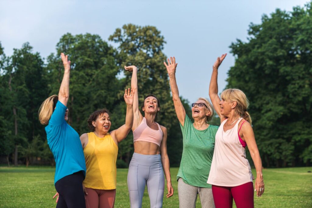 vibrant aging secrets of fitness, sleep and social connections showing a group of older women exercising outdoors together